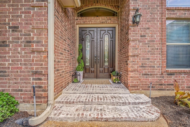 2707 Colony Creek Dr, Bryan, TX 77808 - view of exterior entry featuring brick siding and french doors