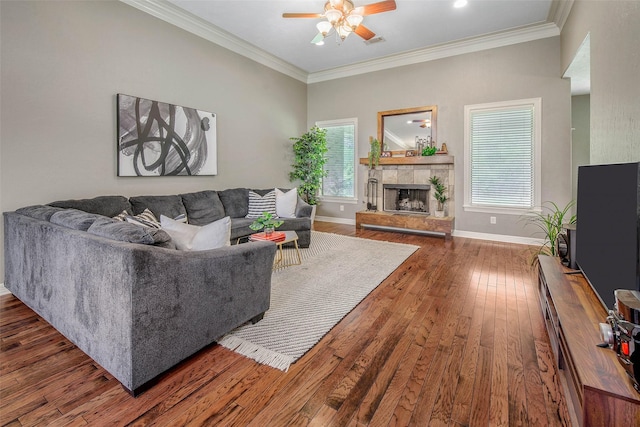 2707 Colony Creek Dr, Bryan, TX 77808 - living room featuring ceiling fan, wood-type flooring, baseboards, crown molding, and a fireplace