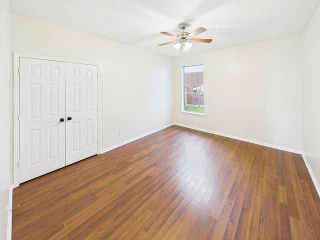 1035 Turnberry Park Ln, Spring, TX 77373 - unfurnished bedroom featuring baseboards, dark wood-style floors, a closet, and a ceiling fan