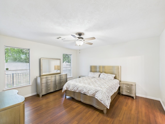 1035 Turnberry Park Ln, Spring, TX 77373 - bedroom featuring dark wood-style flooring, baseboards, and ceiling fan