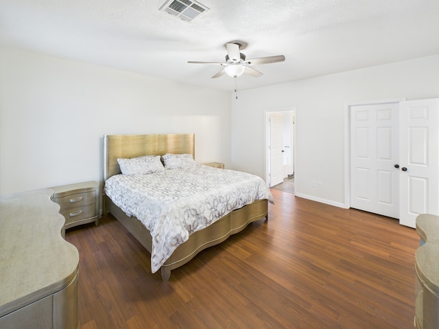 1035 Turnberry Park Ln, Spring, TX 77373 - bedroom with dark wood-style floors, a ceiling fan, and baseboards
