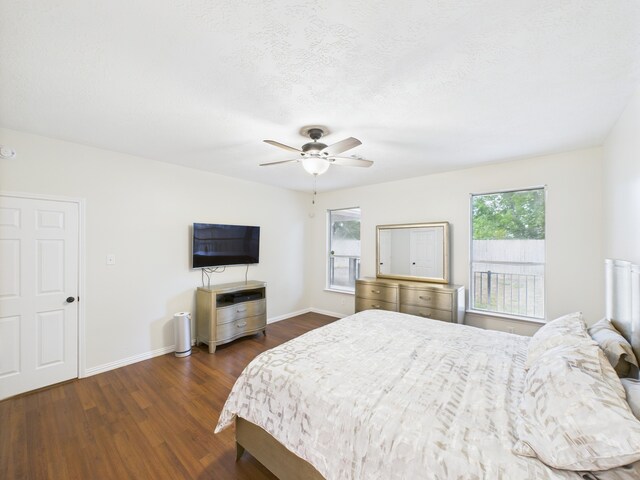1035 Turnberry Park Ln, Spring, TX 77373 - bedroom with dark wood-style flooring, baseboards, and a ceiling fan