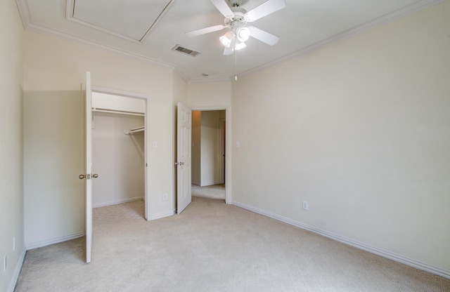 9400 Bellaire Blvd Unit 112, Houston, TX 77036 - unfurnished bedroom with light carpet, a walk in closet, crown molding, baseboards, and a closet