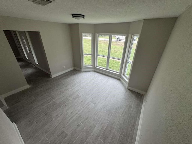 529 Brandon Rd, Conroe, TX 77302 - spare room with wood finished floors, baseboards, and a textured ceiling