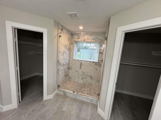 529 Brandon Rd, Conroe, TX 77302 - bathroom featuring a spacious closet, wood finished floors, a marble finish shower, and baseboards