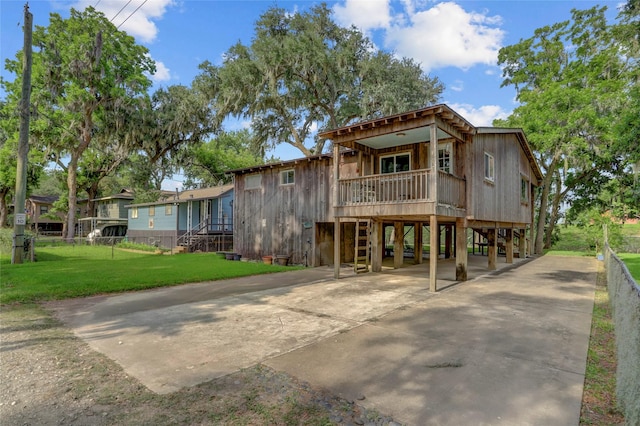 30523 Plantation Dr Unit 37, Damon, TX 77486 - view of front of house with a carport, stairway, a front lawn, concrete driveway, and a porch