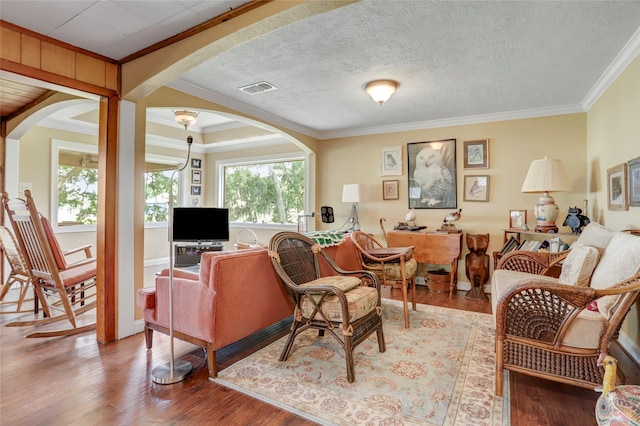30523 Plantation Dr Unit 37, Damon, TX 77486 - living room with arched walkways, ornamental molding, and wood finished floors