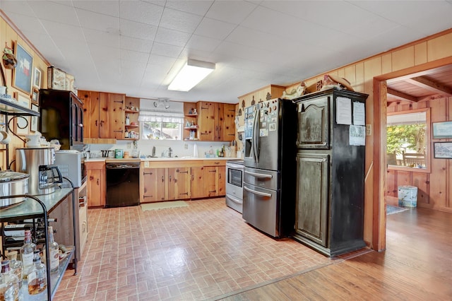 30523 Plantation Dr Unit 37, Damon, TX 77486 - kitchen with appliances with stainless steel finishes, open shelves, wood walls, light countertops, and brick patterned flooring