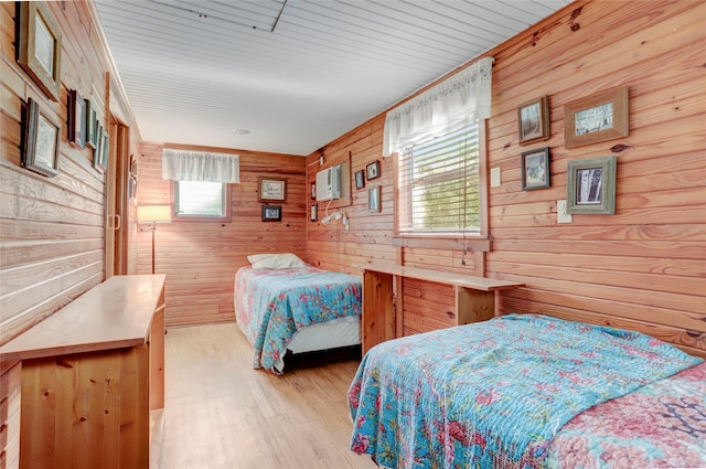 30523 Plantation Dr Unit 37, Damon, TX 77486 - bedroom with wooden walls and light wood-type flooring