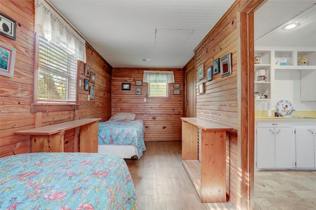 30523 Plantation Dr Unit 37, Damon, TX 77486 - bedroom featuring wooden walls, light wood-style floors, and a sink