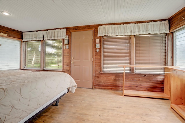 30523 Plantation Dr Unit 37, Damon, TX 77486 - bedroom with wood finished floors and wood walls