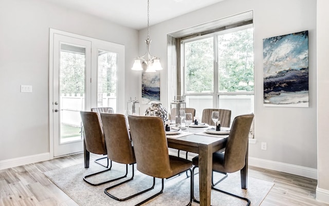 2227 Inglenook Grove Dr, Katy, TX 77493 - dining area with plenty of natural light, a chandelier, light wood-type flooring, and baseboards
