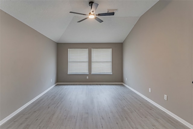 3626 Liles Ln, Humble, TX 77396 - unfurnished room with vaulted ceiling, a ceiling fan, wood finished floors, baseboards, and a textured ceiling