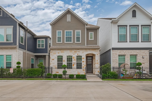 2022 Tarfite Pl, Houston, TX 77077 - multi unit property featuring a fenced front yard and stone siding