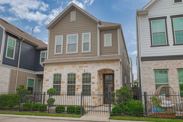 2022 Tarfite Pl, Houston, TX 77077 - view of front facade featuring a fenced front yard and stone siding