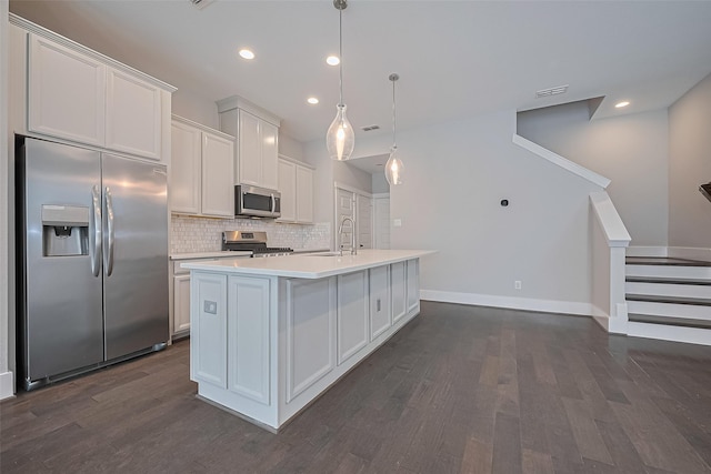 2022 Tarfite Pl, Houston, TX 77077 - kitchen featuring stainless steel appliances, dark wood finished floors, decorative backsplash, light countertops, and an island with sink