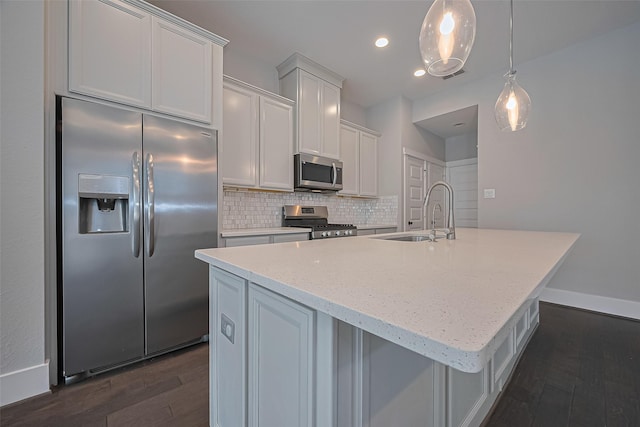 2022 Tarfite Pl, Houston, TX 77077 - kitchen featuring appliances with stainless steel finishes, a sink, dark wood-type flooring, a kitchen island with sink, and tasteful backsplash