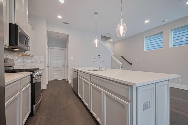 2022 Tarfite Pl, Houston, TX 77077 - kitchen with stainless steel appliances, a sink, dark wood finished floors, tasteful backsplash, and recessed lighting
