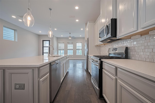 2022 Tarfite Pl, Houston, TX 77077 - kitchen featuring appliances with stainless steel finishes, a sink, backsplash, dark wood-type flooring, and recessed lighting