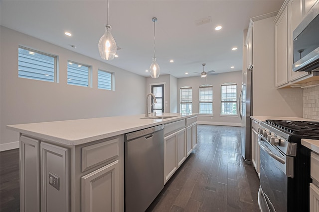 2022 Tarfite Pl, Houston, TX 77077 - kitchen featuring appliances with stainless steel finishes, a sink, light countertops, plenty of natural light, and recessed lighting