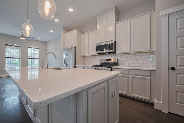 2022 Tarfite Pl, Houston, TX 77077 - kitchen featuring stainless steel appliances, a sink, dark wood-style flooring, a ceiling fan, and tasteful backsplash