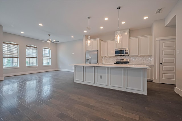 2022 Tarfite Pl, Houston, TX 77077 - kitchen featuring appliances with stainless steel finishes, baseboards, backsplash, white cabinets, and recessed lighting