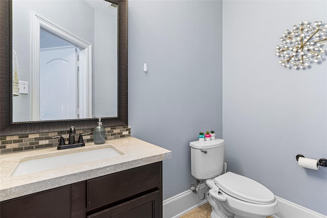 16714 Radiant Lilac Trl, Cypress, TX 77433 - half bath with toilet, baseboards, vanity, and tasteful backsplash