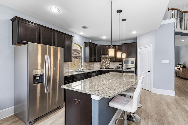 16714 Radiant Lilac Trl, Cypress, TX 77433 - kitchen featuring appliances with stainless steel finishes, a sink, tasteful backsplash, baseboards, and light stone counters