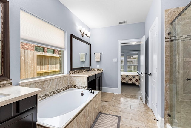 16714 Radiant Lilac Trl, Cypress, TX 77433 - ensuite bathroom featuring vanity, a garden tub, and a shower stall