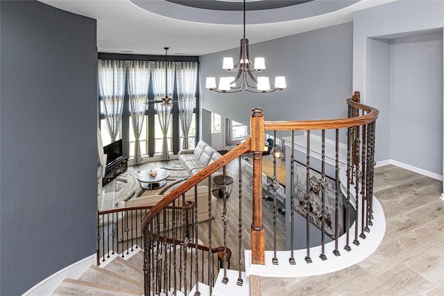 16714 Radiant Lilac Trl, Cypress, TX 77433 - stairs with a chandelier, wood finished floors, and baseboards
