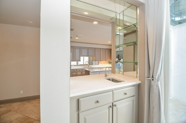 6 River Hollow Ln, Houston, TX 77027 - kitchen with a sink, light countertops, light tile patterned floors, baseboards, and recessed lighting