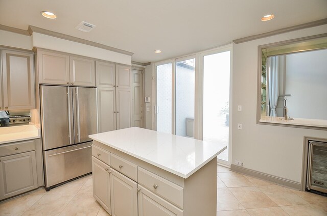6 River Hollow Ln, Houston, TX 77027 - kitchen featuring high quality fridge, recessed lighting, light countertops, light tile patterned floors, and a kitchen island