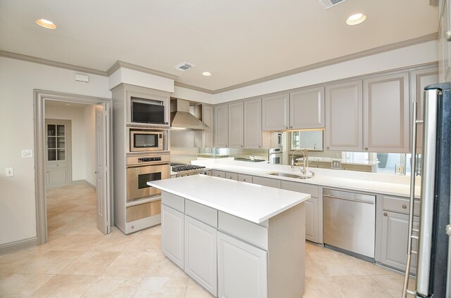 6 River Hollow Ln, Houston, TX 77027 - kitchen featuring appliances with stainless steel finishes, a sink, gray cabinets, wall chimney exhaust hood, and a center island