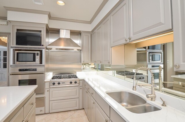 6 River Hollow Ln, Houston, TX 77027 - kitchen featuring stainless steel appliances, wall chimney exhaust hood, a warming drawer, a sink, and light tile patterned floors