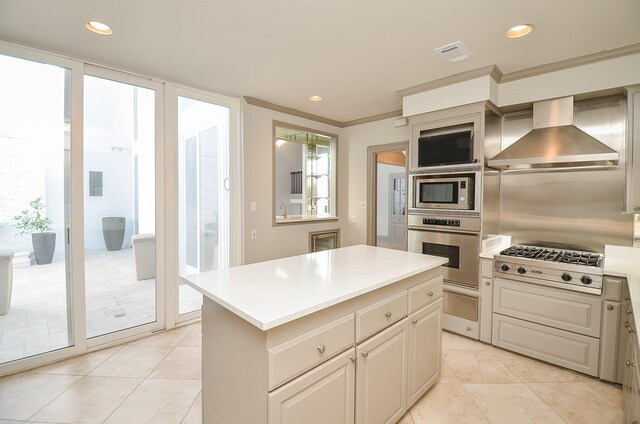 6 River Hollow Ln, Houston, TX 77027 - kitchen featuring stainless steel appliances, wall chimney range hood, light tile patterned flooring, a kitchen island, and recessed lighting