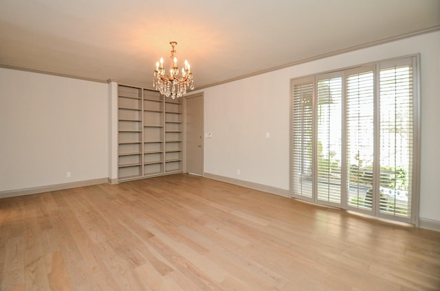 6 River Hollow Ln, Houston, TX 77027 - unfurnished room with a chandelier, healthy amount of natural light, light wood-style flooring, built in features, and crown molding