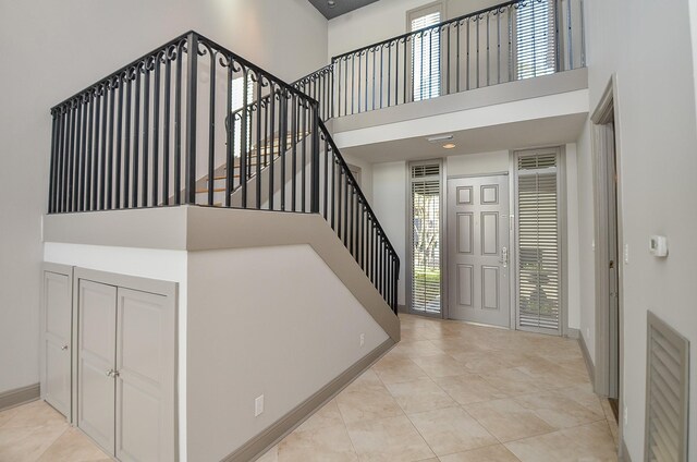 6 River Hollow Ln, Houston, TX 77027 - foyer entrance with a towering ceiling, healthy amount of natural light, stairs, and light tile patterned flooring