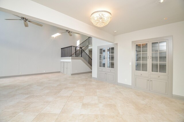 6 River Hollow Ln, Houston, TX 77027 - unfurnished living room with ceiling fan, a chandelier, stairs, and baseboards