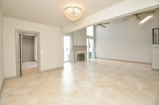 6 River Hollow Ln, Houston, TX 77027 - unfurnished living room featuring a ceiling fan, a fireplace, a chandelier, and baseboards