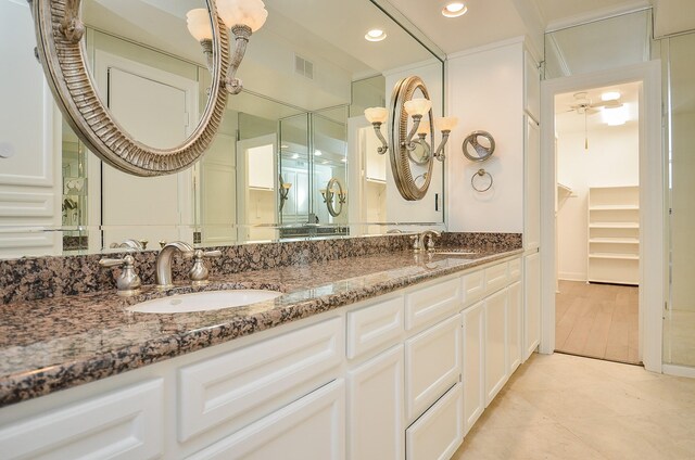 6 River Hollow Ln, Houston, TX 77027 - bathroom featuring double vanity, recessed lighting, tile patterned floors, and a walk in closet