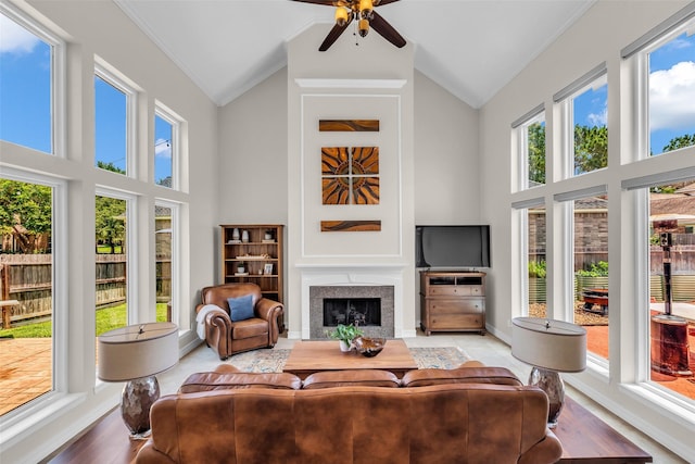 25607 Ryans Creek Ct, Katy, TX 77494 - living area with high vaulted ceiling, a ceiling fan, a fireplace, baseboards, and ornamental molding