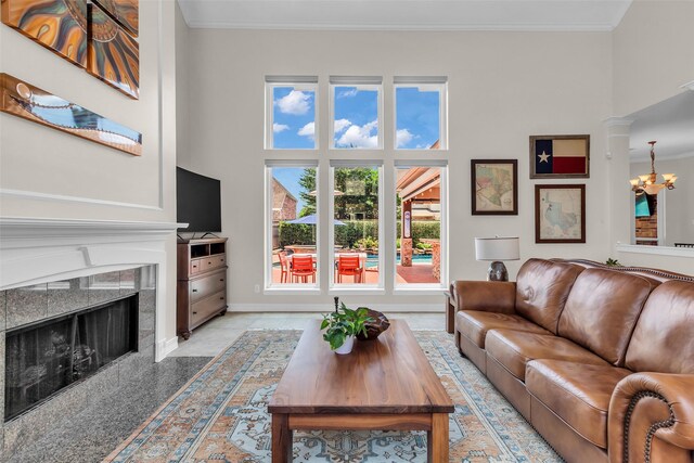25607 Ryans Creek Ct, Katy, TX 77494 - living area featuring a chandelier, ornamental molding, a premium fireplace, and baseboards