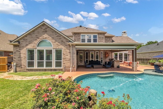 25607 Ryans Creek Ct, Katy, TX 77494 - rear view of house with outdoor lounge area, brick siding, a patio area, and a chimney