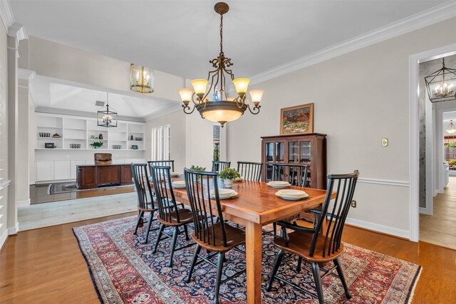 25607 Ryans Creek Ct, Katy, TX 77494 - dining area featuring a chandelier, ornamental molding, baseboards, and wood finished floors