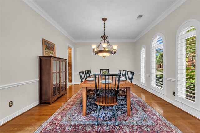 25607 Ryans Creek Ct, Katy, TX 77494 - dining space with crown molding, a chandelier, wood finished floors, and baseboards