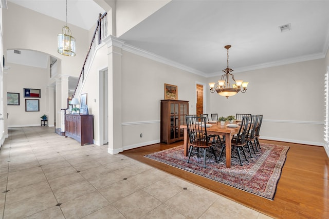 25607 Ryans Creek Ct, Katy, TX 77494 - tiled dining space with a chandelier, arched walkways, baseboards, and crown molding