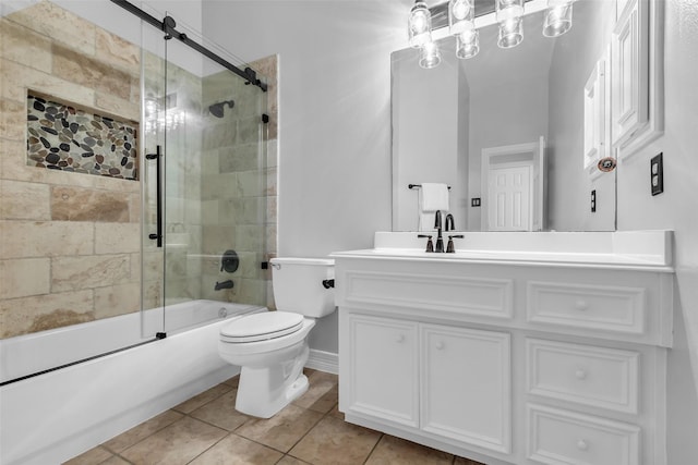 25607 Ryans Creek Ct, Katy, TX 77494 - bathroom with vanity, combined bath / shower with glass door, toilet, tile patterned flooring, and baseboards