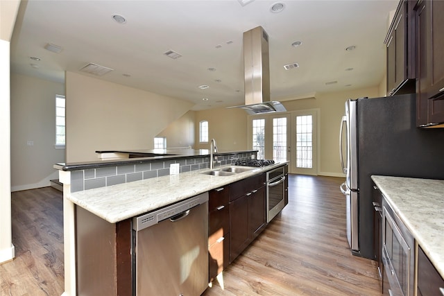 5525 Petty St Unit A, Houston, TX 77007 - kitchen featuring stainless steel appliances, a sink, island range hood, baseboards, and recessed lighting