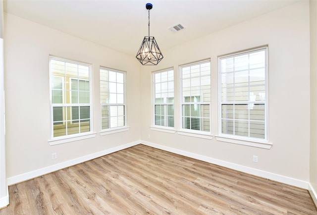 5525 Petty St Unit A, Houston, TX 77007 - unfurnished room with a chandelier, baseboards, and wood finished floors