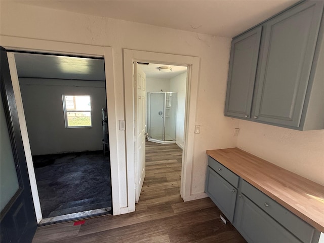 445 W Vaughan St, Bertram, TX 78605 - kitchen featuring gray cabinets, butcher block counters, dark wood finished floors, and baseboards